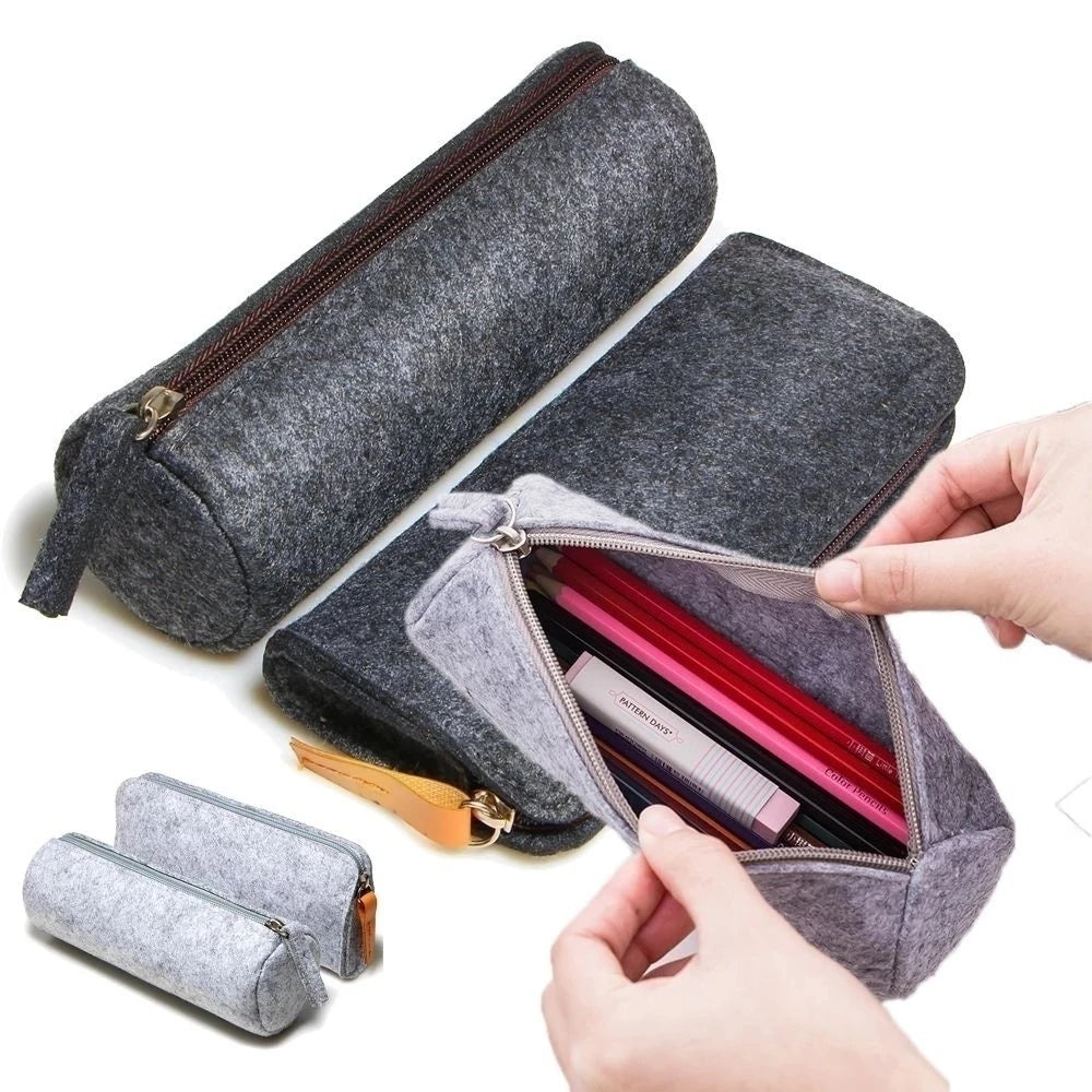 Gray felt pencil case with a hand opening it to reveal stationery items on a white background
